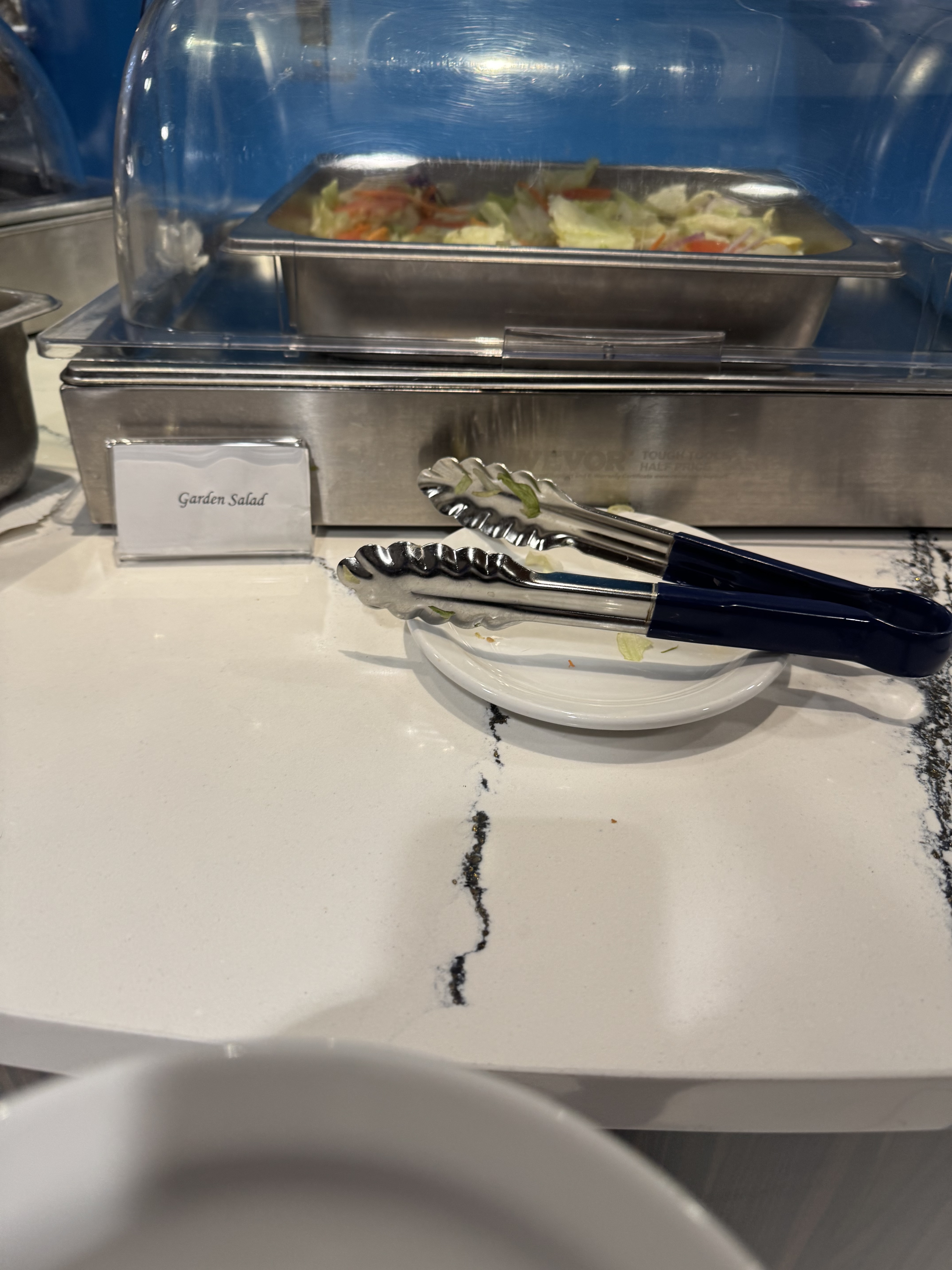 KLM Crown Lounge food display with chips and cookies